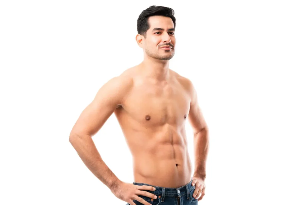 Man flexing his abs after tummy tuck scars have healed
