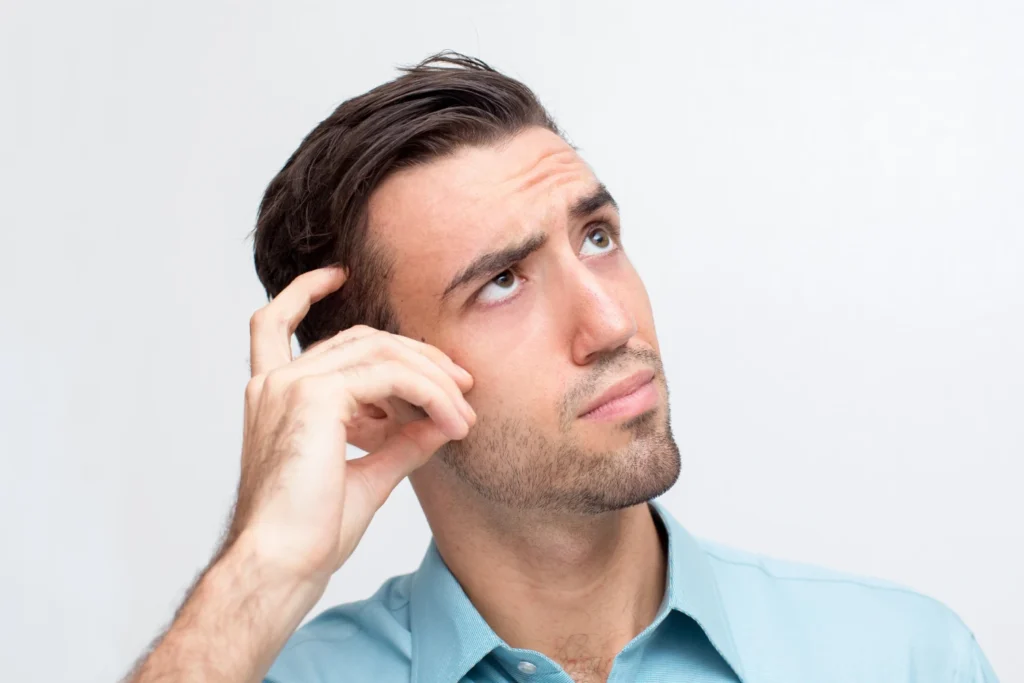 Man flexing the results of his plastic surgery to get defined jawline