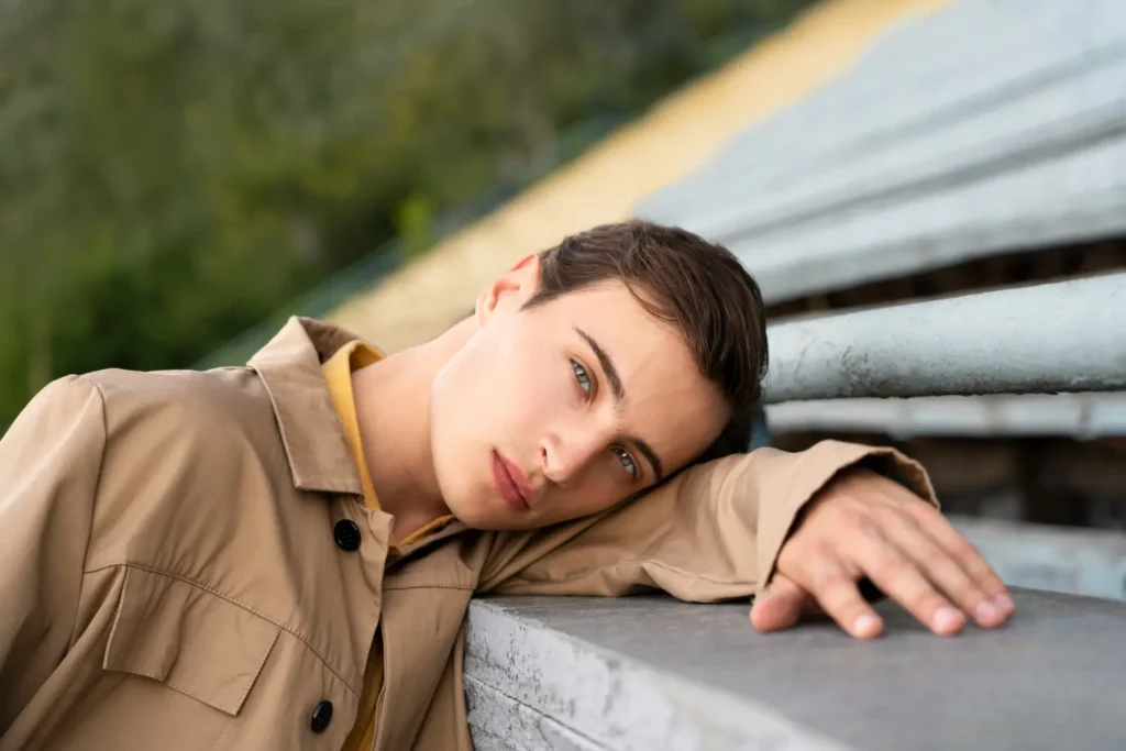 Man posing by the stairs and flexing sharp jawline after getting Botox