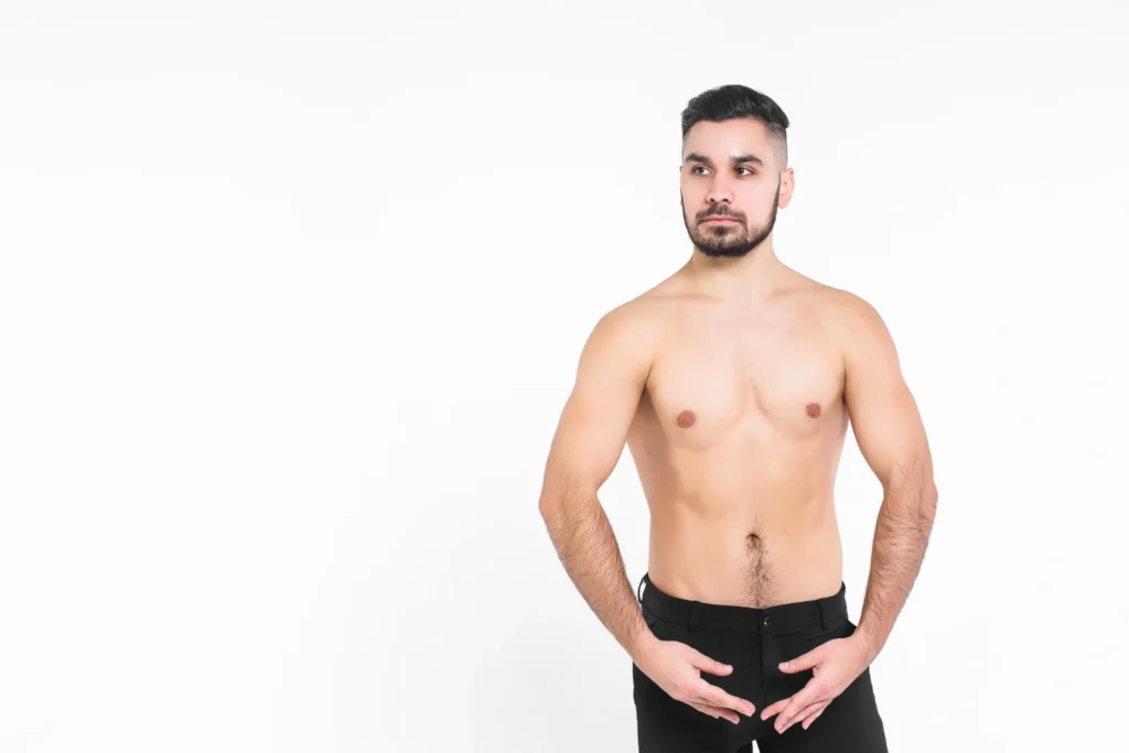 Shirtless man wearing black shorts after avelar tummy tuck recovery