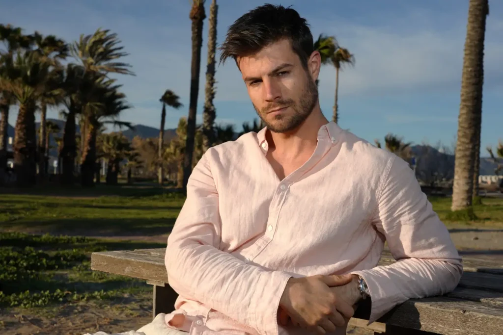 Man wearing white shirt with long sleeves outside and flexing PDO thread lift results