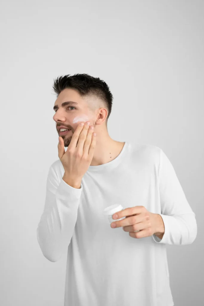 Man applying skincare cream while considering options for places to get Botox treatments
