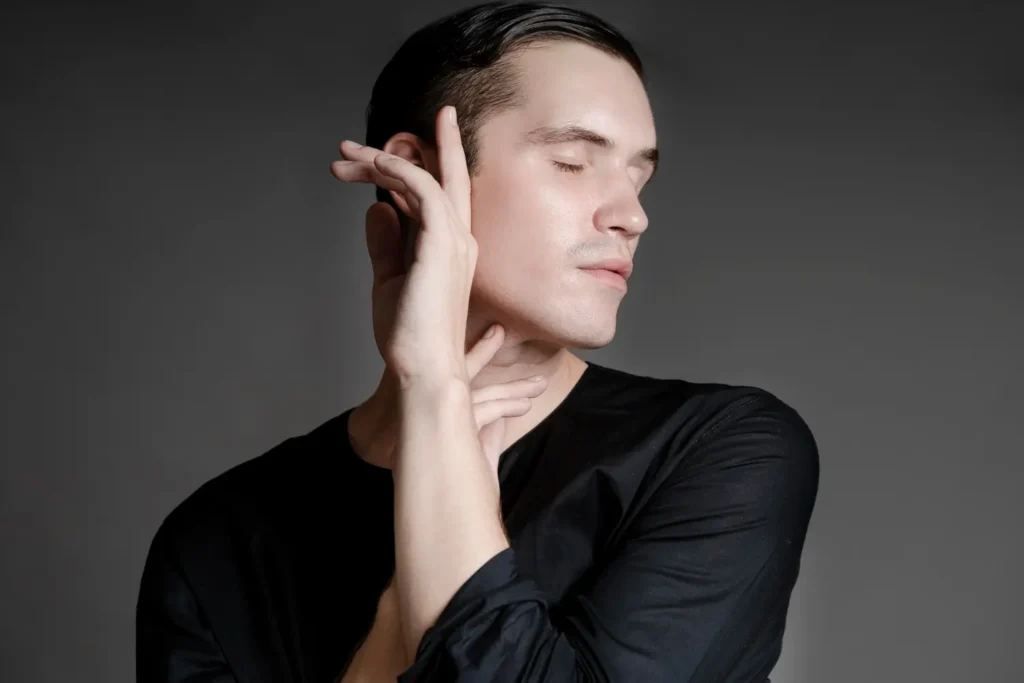 Man touching his jawline and neck area examining signs of aging that PDO threads