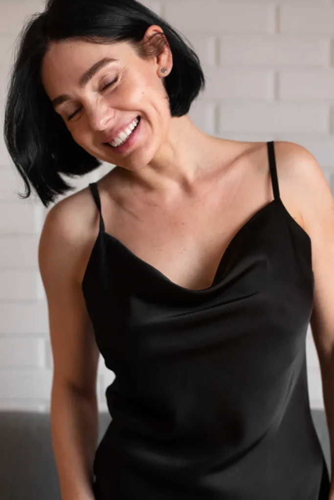 Medium shot smiley woman posing at home