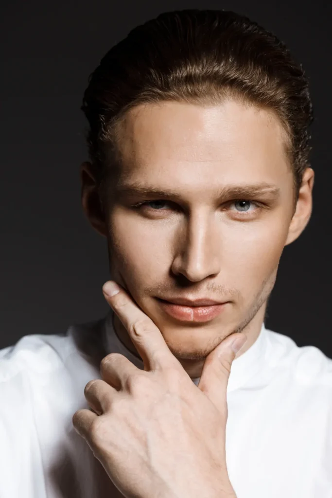 Portrait of attractive caucasian man over grey wall