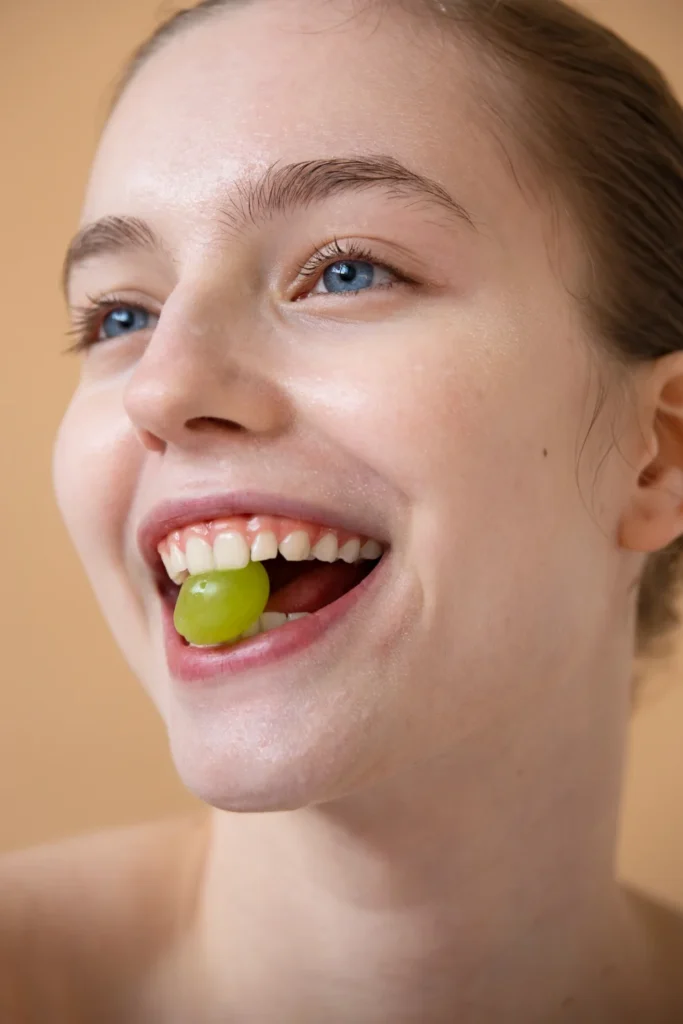 Side view smiley woman with grape