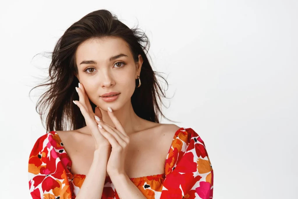 Tender brunette woman wearing natural makeup floral blouse