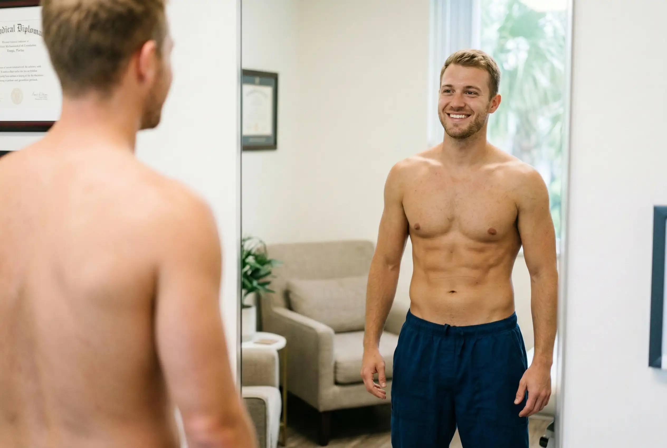 fit man looking at the mirror