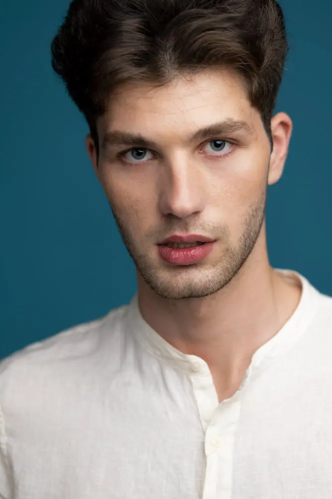 man posing with blue background front view