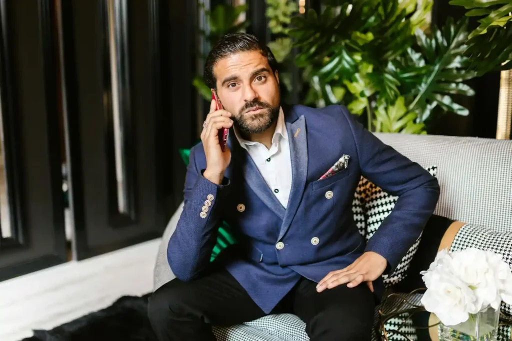 Handsome man posing while talking to the phone flexing his PDO thread lift result