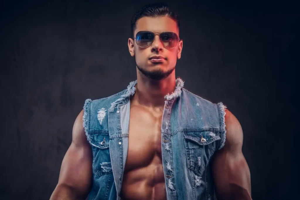 Man wearing glasses and denim jacket with his bulging muscles after plastic surgery recovery