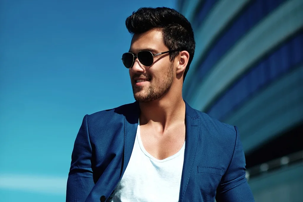 Man wearing shades and a blue coat looking very sharp and masculine after PDO thread lift