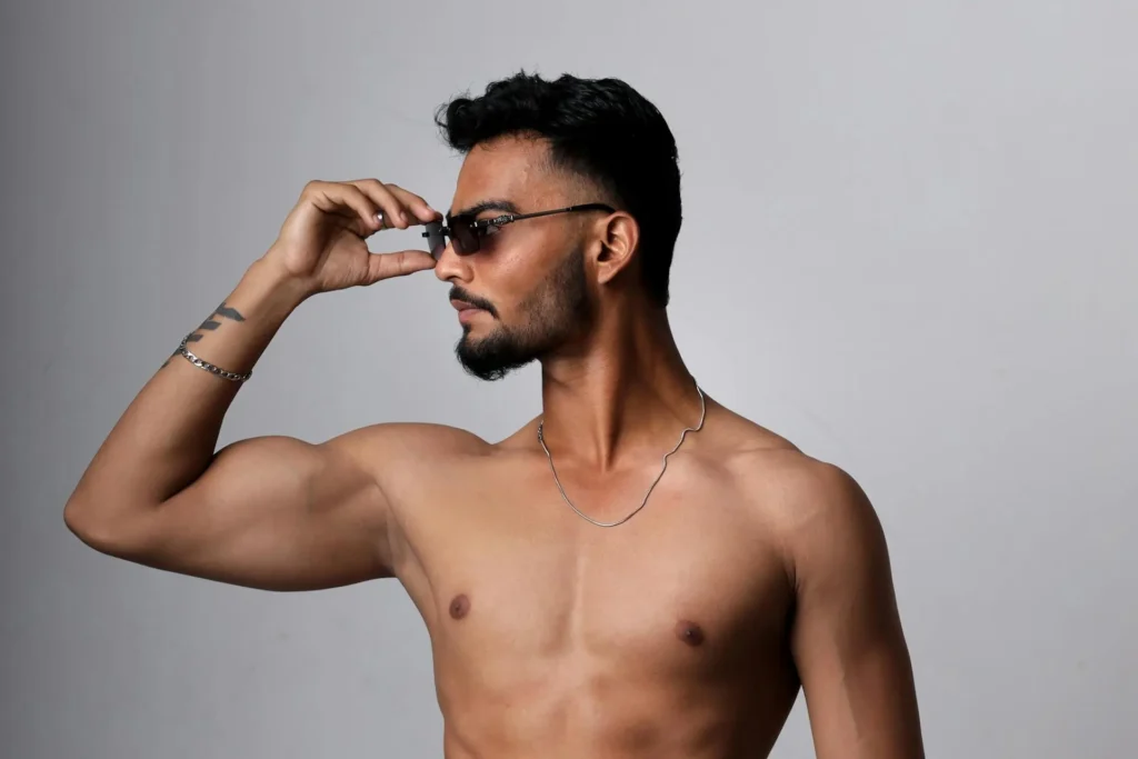 Shirtless man flexing the results of his neck liposuction procedure
