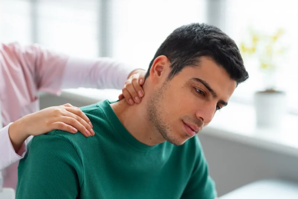 A close-up shot of a man during a post-operative check-up for neck liposuction