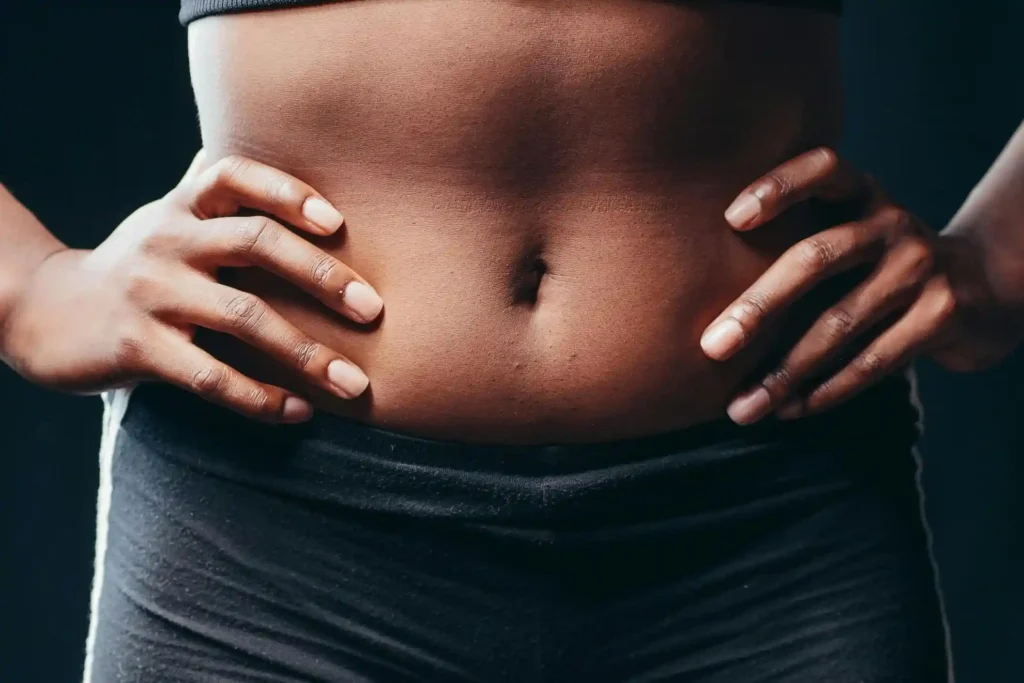 Close up shot of a woman's belly after recovering from plastic surgery