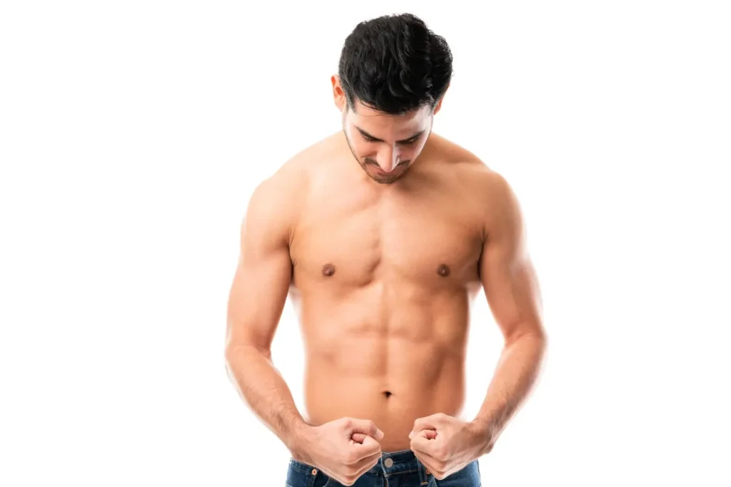 Fit man with toned abdominal muscles showcasing improved posture after tummy tuck surgery