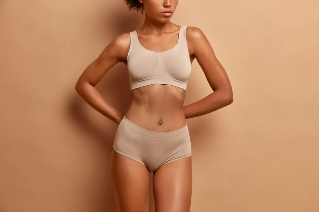 Woman wearing her undergarments and looking beautiful and well built after plastic surgery