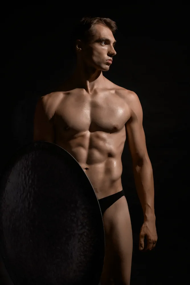 young fit strong man with perfect muscular body after plastic surgery