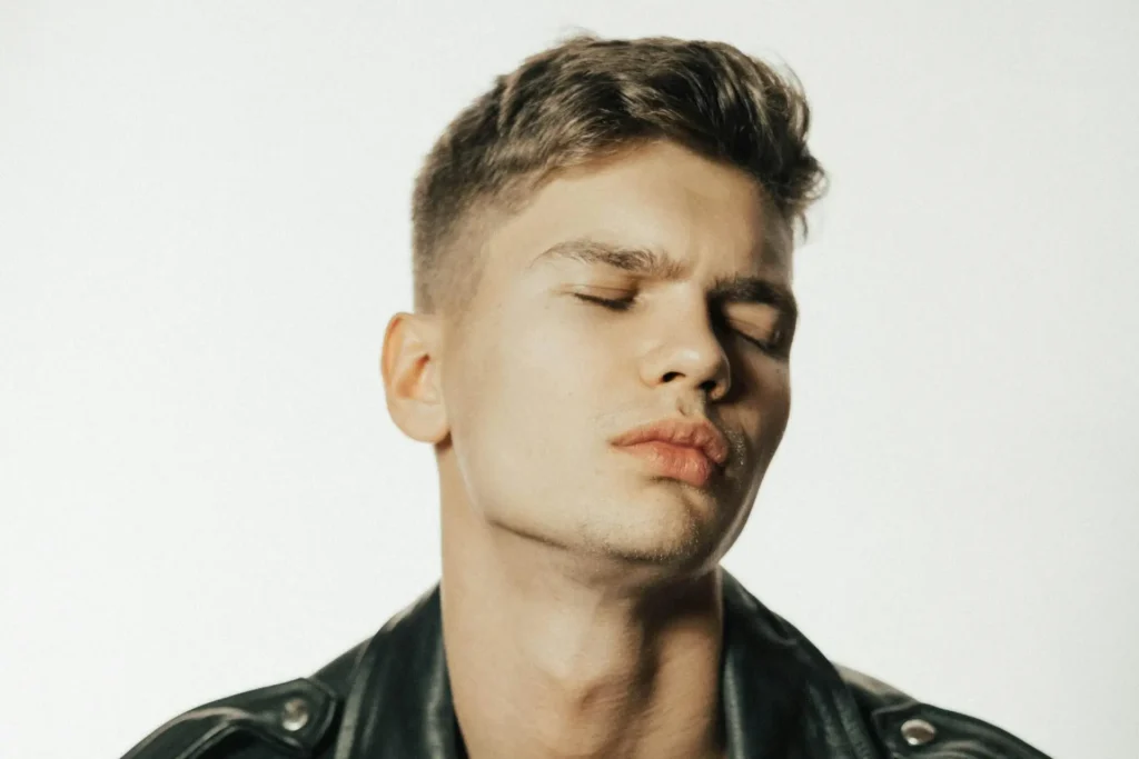 Man showing the left side of his handsome face after getting a jawline filler treatment