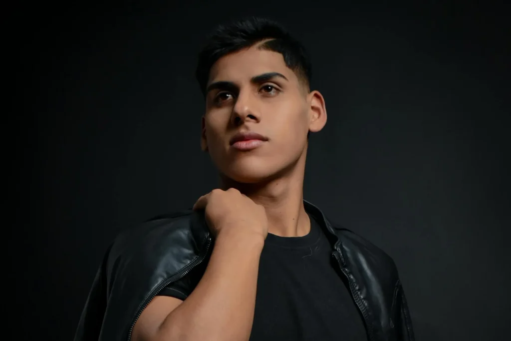 Man with black background showing his FaceTite results