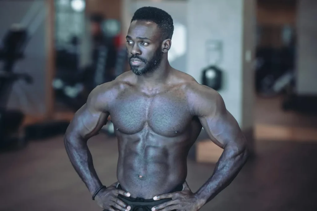 Medium shot of a man flexing his abs after HD liposuction procedure