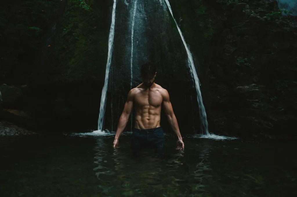 Wide shot of a man enjoying the falls and showing off his HD lipo results