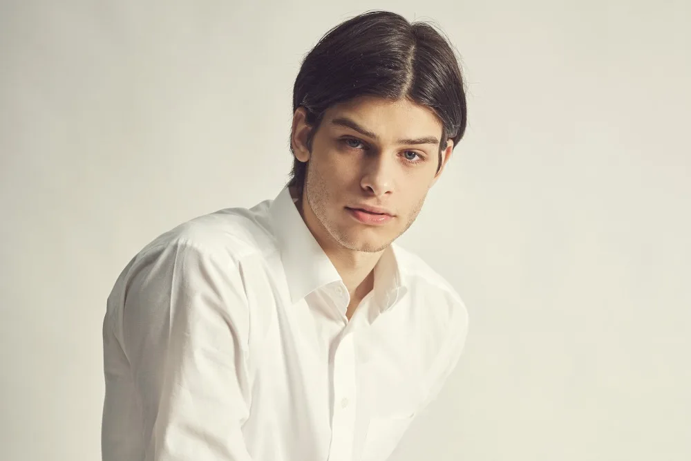 Man wearing white polo and flexing his PDO threads