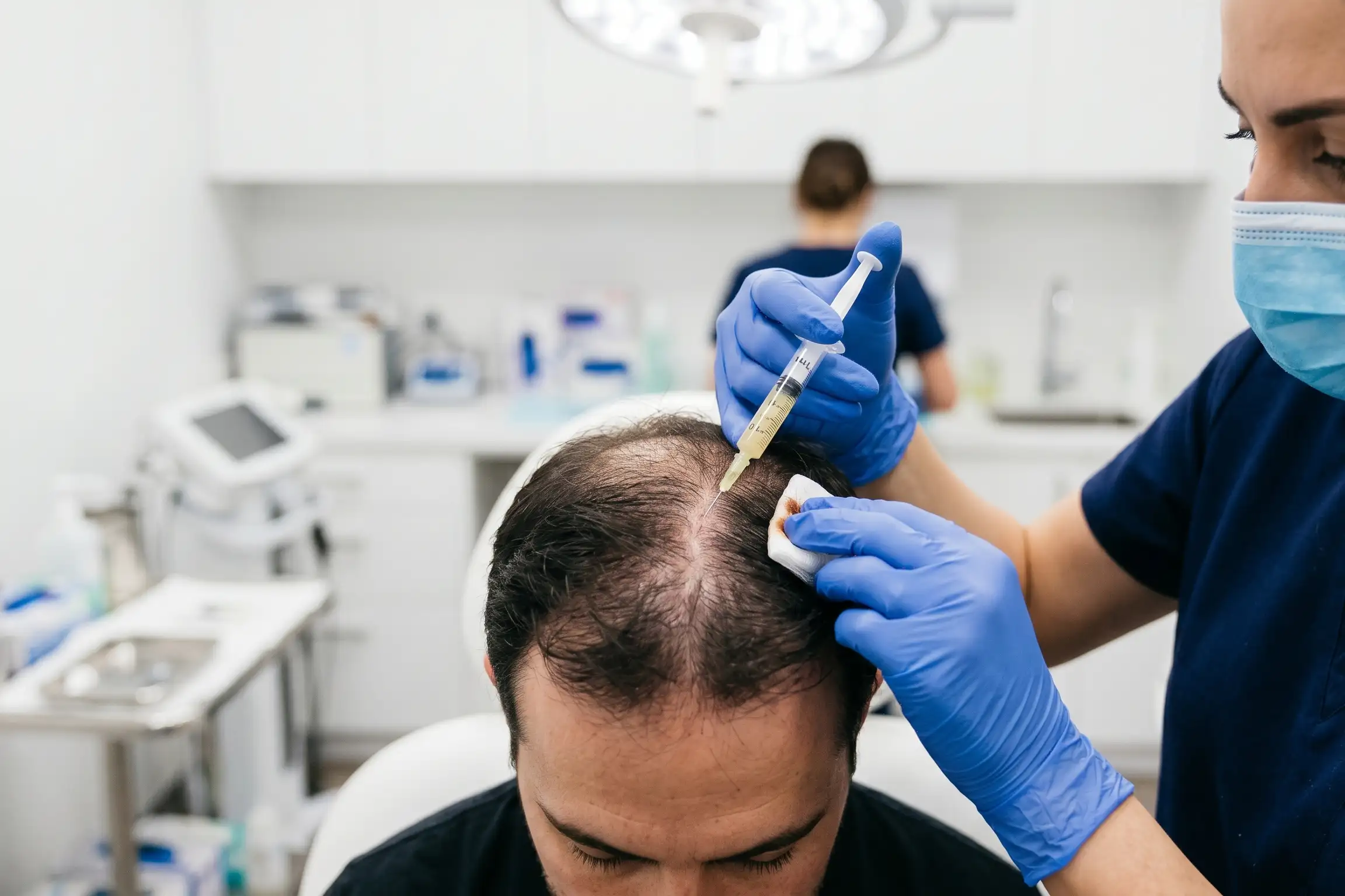 Clinician giving a PRP scalp injection for hair restoration in Tampa