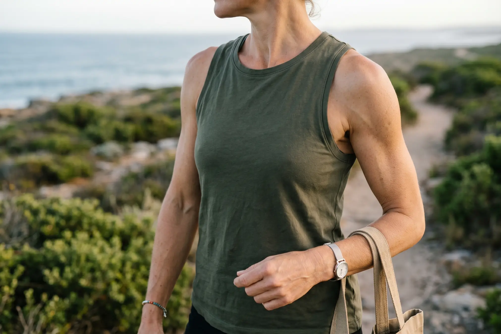Woman with slim toned arms showing lasting arm liposuction results