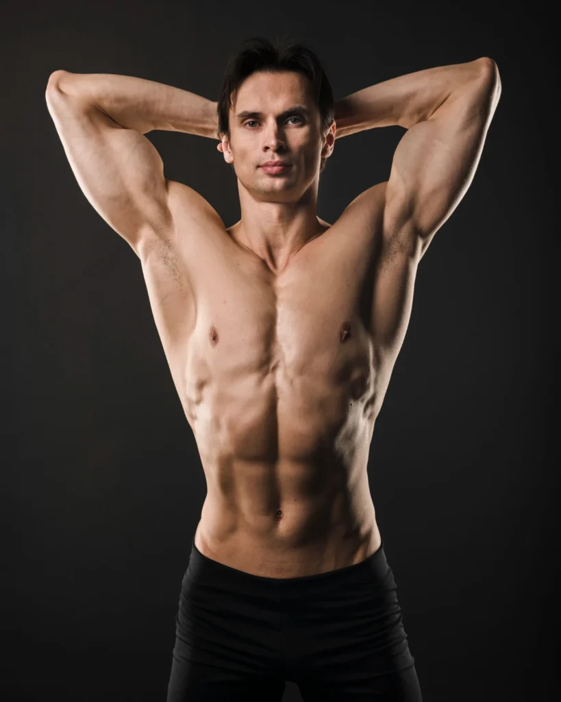 Shirtless athletic man posing with arms up