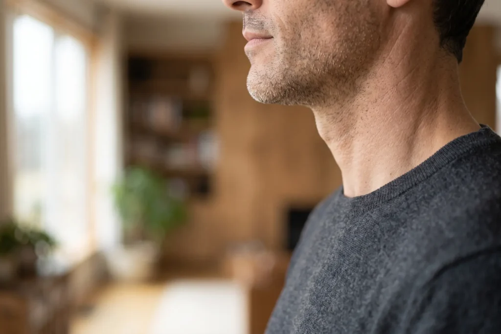 Man with a naturally defined jawline after neck liposuction in Gandy-Sun Bay South