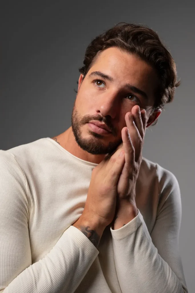 young handsome man touching his face
