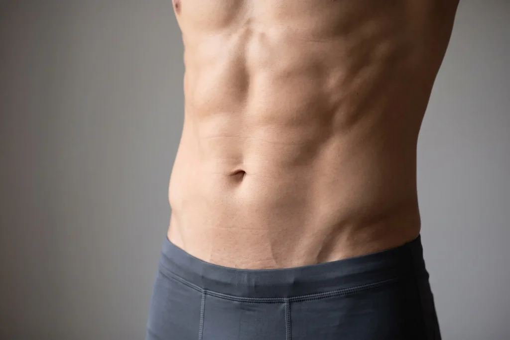 Athletic male midsection illustrating natural high-definition liposuction contour at Formation