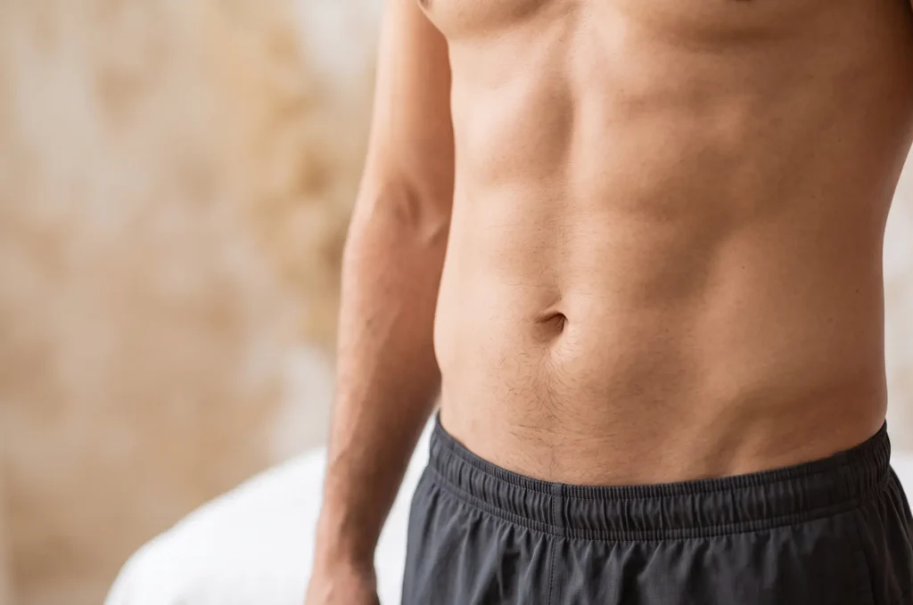 Natural HD liposuction result showing an athletic male midsection near Rembrandt Gardens Tampa