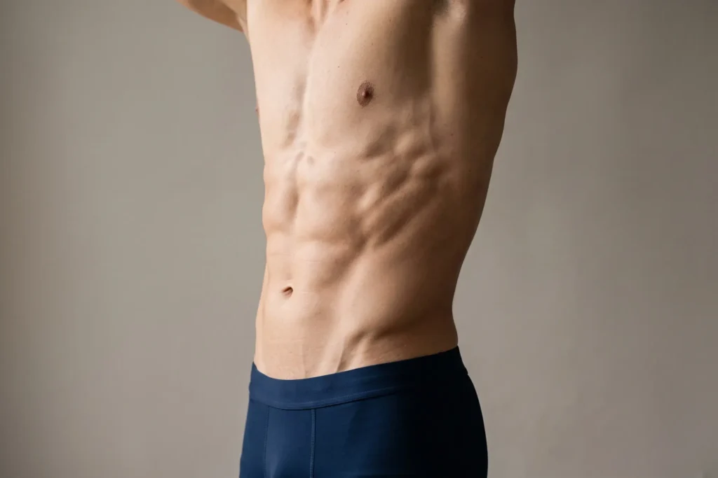 Athletic male torso showing natural definition after liposuction, Pinellas Park patient