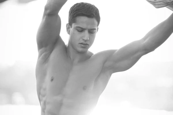 Black and white photo of a man showing his chest after high def liposuction