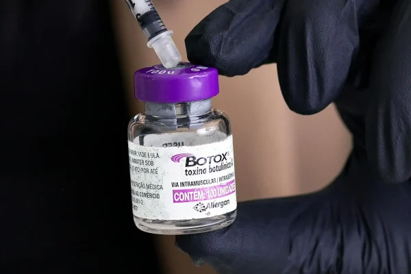 Cosmetic surgeon holding a Botox vial and syringe
