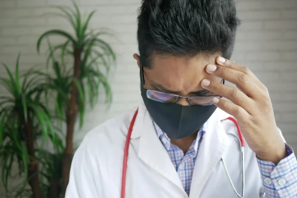 Male plastic surgeon weighing the pros and cons of PDO threads