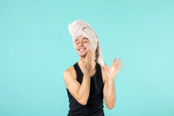 Man prepping his skin and putting soap to his face after Botox