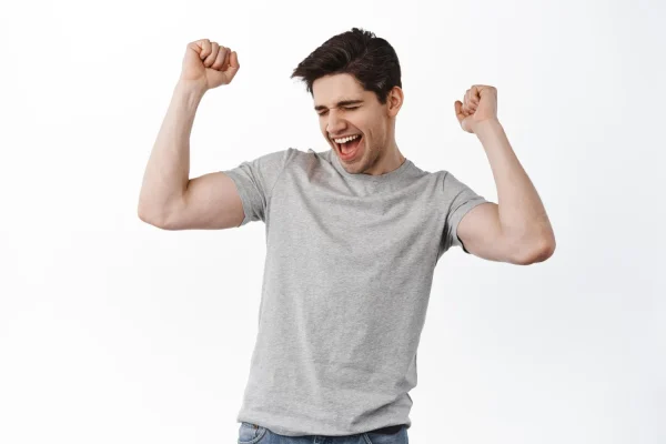 Man raising both arms and looking so happy after getting plastic surgery