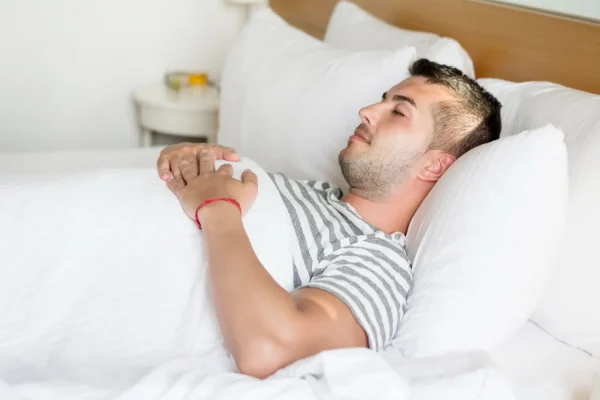 Man resting while recovering from neck liposuction surgery
