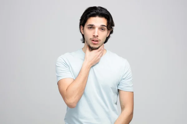 Man touching his neck and thinking about neck and jawline contouring