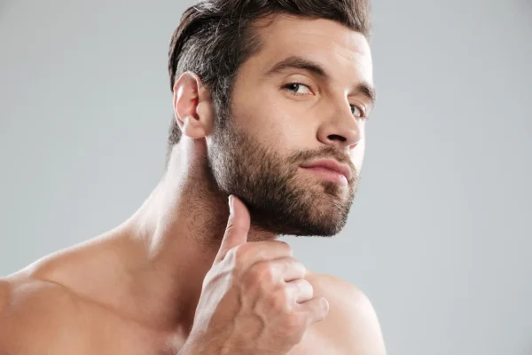 Man touching jaw and planning of getting jawline fillers