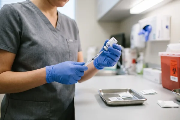Physician assistant preparing a subcutaneous peptide injection in a Tampa clinic