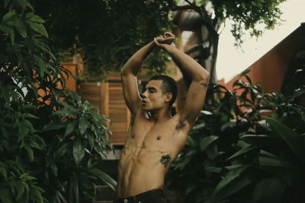 Shirtless man showing tummy tuck results