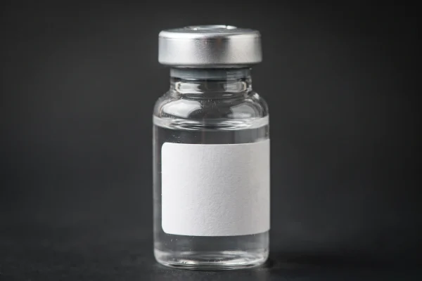 Close-up of a peptide vial like those used in GLP-1 and growth hormone peptide therapy