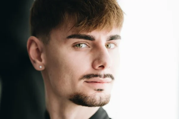 Man flexing the results of his non-invasive jawline procedure