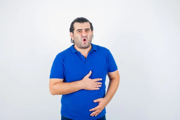 Man looking worried after seeing that he may have an uneven HD liposuction result