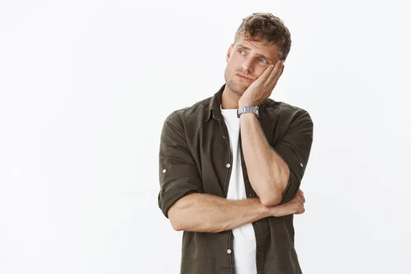 Man thinking very hard after noticing some symptoms of liposuction infection