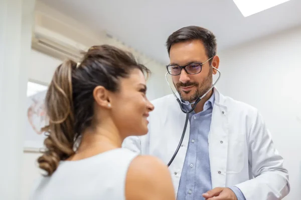 Plastic surgeon assessing a patient before performing smart liposuction